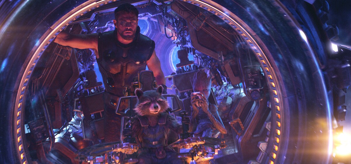 Avengers: Infinity War (2018): Thor stands behind Rocket and Groot inside a spacecraft lit in blue and purple