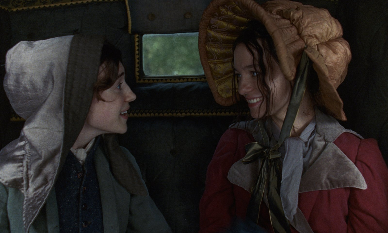 Sense and Sensibility (2026) — the Dashwood sisters share a carriage Sense and Sensibility (2026): Daisy Edgar-Jones and Esmé Creed-Miles smile toward each other in bonnets inside a carriage