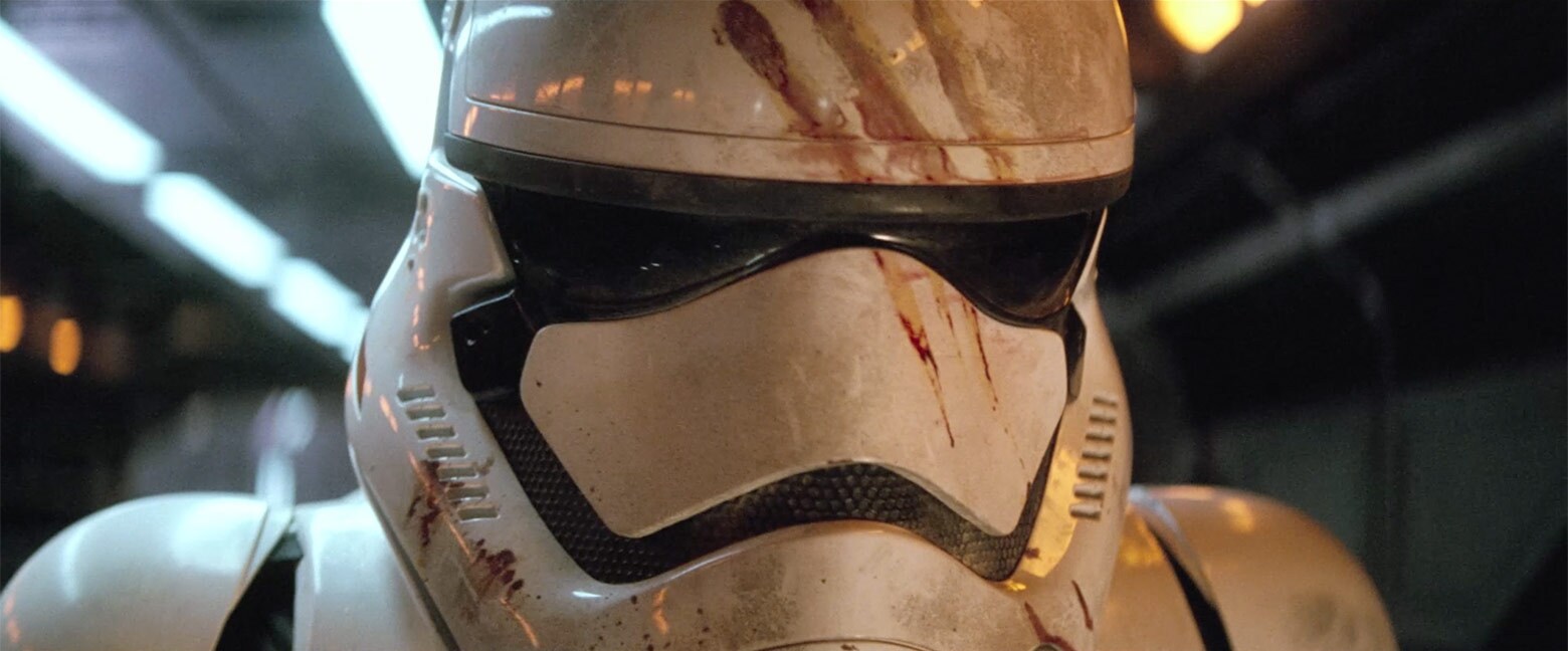 Star Wars: The Force Awakens (2015) — Finn inside a blood-marked stormtrooper helmet Star Wars: The Force Awakens (2015): Finn wears a white stormtrooper helmet marked with red blood streaks